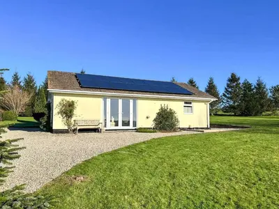 a house with solar panels on top of it at Badgers Drift in Doublebois