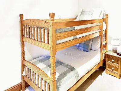 a couple of bunk beds in a bedroom at Penty Rosen in Pentewan
