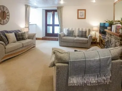 a living room with two couches and a tv at Anneth Lowen in Pentewan
