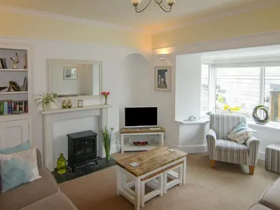 a living room with a tv and a fireplace at Seaview in Gorran Haven