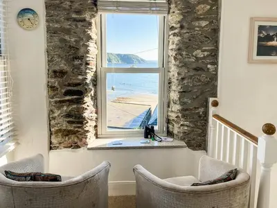 a room with two chairs in front of a window at Seaview in Gorran Haven