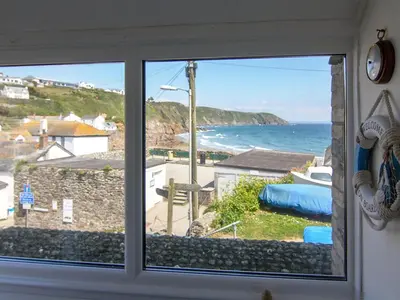 a window with a view of the ocean at Seaview in Gorran Haven