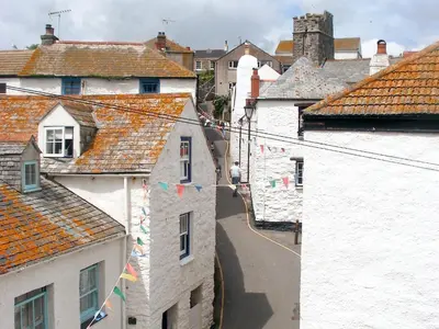 a view of a town with flags and buildings at The Gables in Gorran Haven