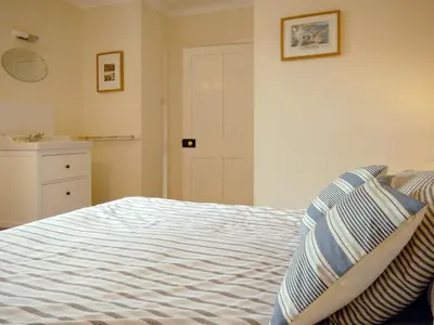 a bedroom with a bed and a sink at The Gables in Gorran Haven