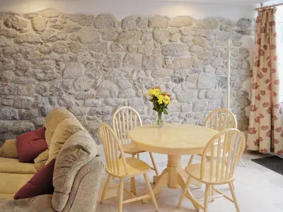 a dining room with a table and chairs at The Old Coach House in St Austell