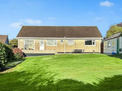a house with a large lawn in front of it at Goonlaze in St Austell