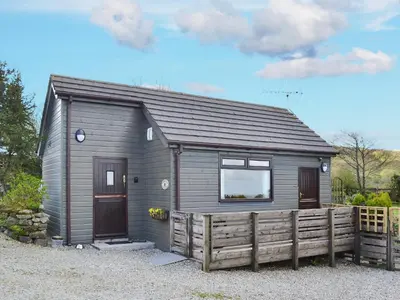 a small house with a wooden fence in front of it at Scholten Lodge in Roche