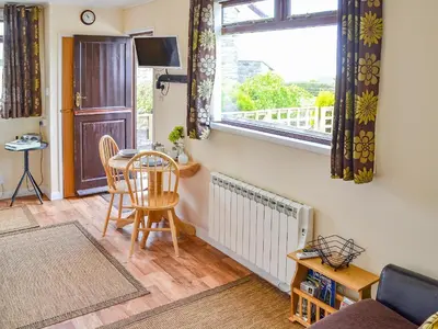 a living room with a table and a window at Scholten Lodge in Roche