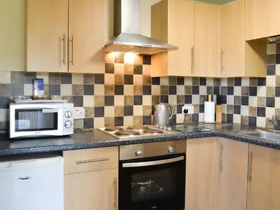 a kitchen with a microwave oven and a sink at Scholten Lodge in Roche