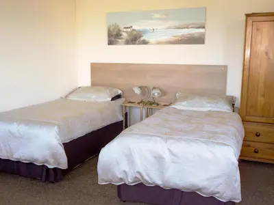 a hotel room with two beds and a night stand at Scholten Lodge in Roche
