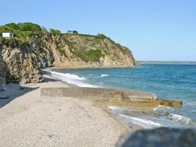 a beach with the ocean and a rocky coastline at Scholten Lodge in Roche