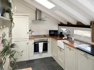 a kitchen with white cabinets and a sink at Millie's Place in Saint Stephen