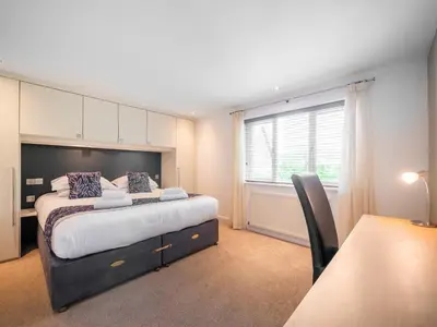 a bedroom with a large bed and a window at Villa Gallery- 27073 in Perranwell