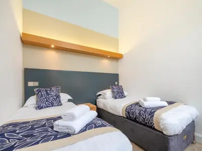a room with two beds with towels on them at Villa Gallery - 27074 in Perranwell