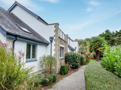 a white house with a garden and a pathway at Villa Gallery - 27074 in Perranwell