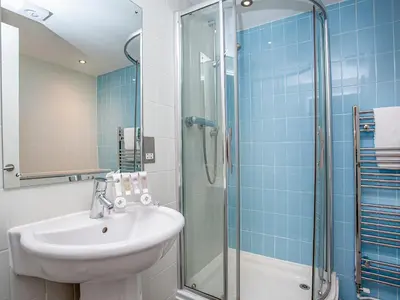 a bathroom with a sink and a shower at Valley Gallery - 27075 in Perranwell