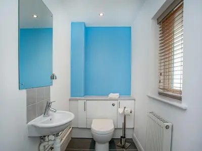 a bathroom with a white toilet and a sink at Valley Gallery - 27075 in Perranwell