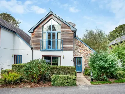 a white house with a blue door at Haven -78 in Perranwell
