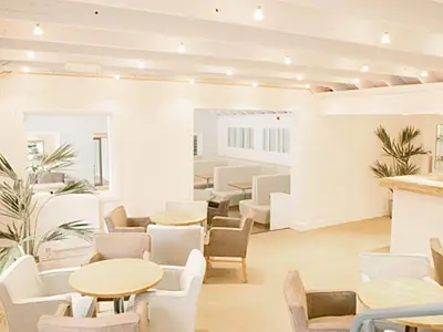 a waiting room with tables and chairs at Haven -78 in Perranwell