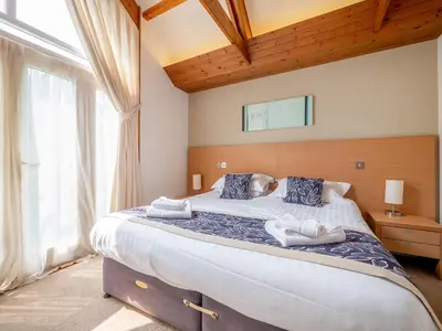 a bedroom with a large bed with towels on it at Haven -78 in Perranwell