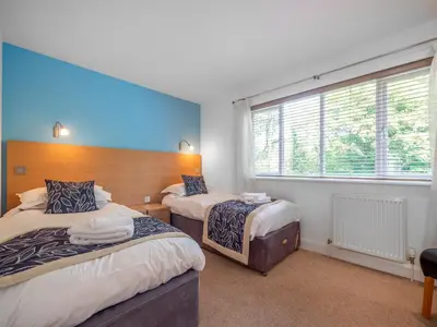 a bedroom with two beds and a window at Haven -79 in Perranwell
