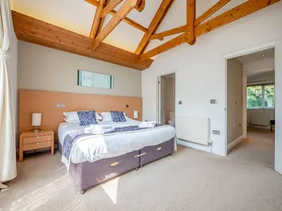 a bedroom with a large bed and a wooden ceiling at Haven -80 in Perranwell