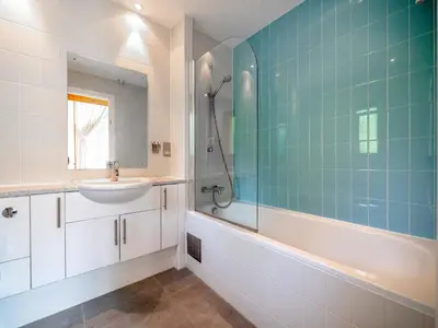 a bathroom with a sink and a tub and a shower at Haven -80 in Perranwell