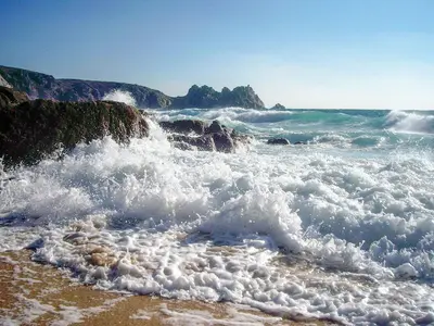 a group of waves crashing on a beach at The Stable in Crowan