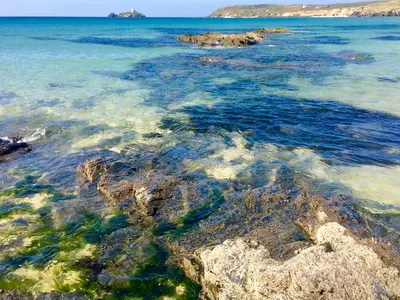 a view of the ocean with rocks in the water at The Stable in Crowan