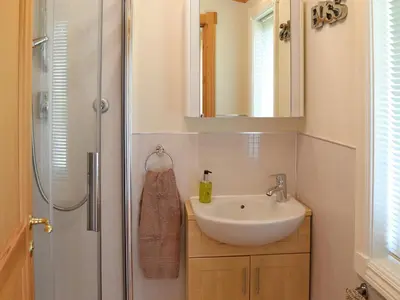 a bathroom with a sink and a shower at Wheal Metal Lodge in Carleen