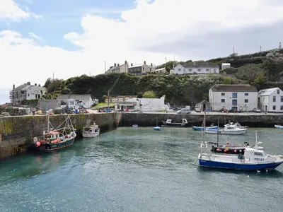 a group of boats are docked in a harbor at Thatch Cottage in Saint Hilary