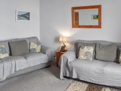 a living room with a couch and a chair at Hillside in Praa Sands