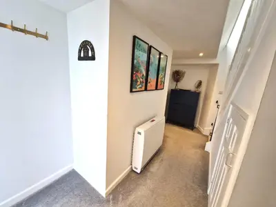 a hallway of a house with a white radiator at Very Spacious, Great location. Castle and Sea view in Marazion