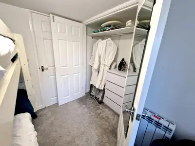 a walk in closet with a white door at Very Spacious, Great location. Castle and Sea view in Marazion