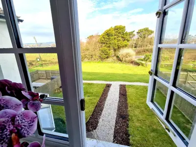 an open window with a view of a yard at Very Spacious, Great location. Castle and Sea view in Marazion
