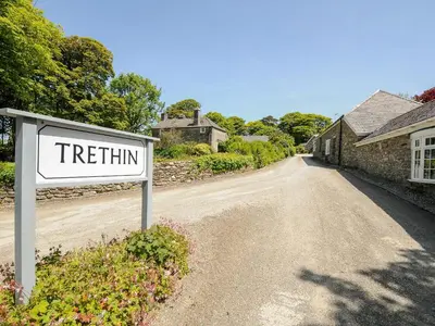 a sign on the side of a dirt road at Byre in Camelford