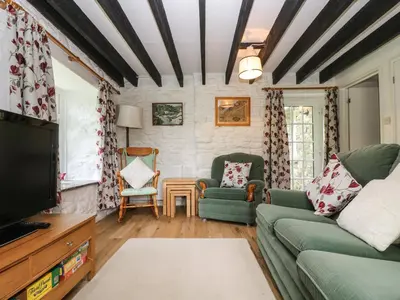 a living room with a couch and a tv at Byre in Camelford