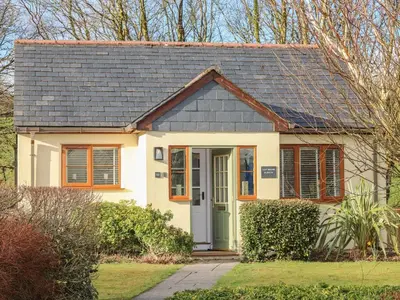 a small white house with a gray roof at Inny Brook Burrow in Camelford