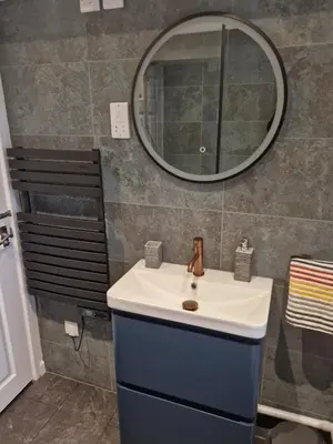 a bathroom with a sink and a mirror at Great location very spacious. Sea and castle view in Marazion