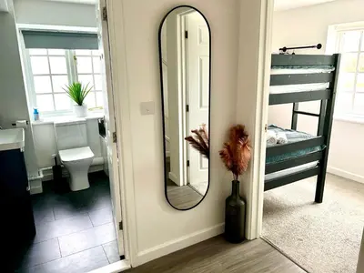 a bathroom with a mirror and a bunk bed at Great location very spacious. Sea and castle view in Marazion