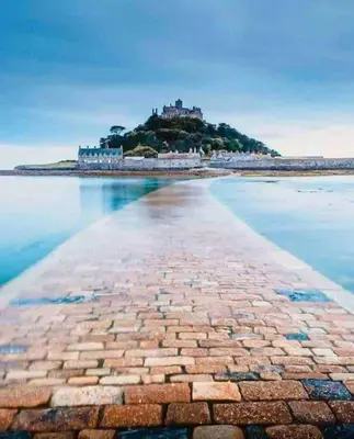 a brick road leading to an island in the water at Great location very spacious. Sea and castle view in Marazion