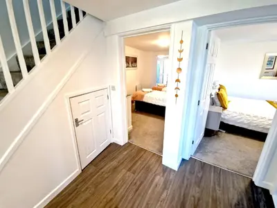 a room with a staircase and a bedroom at Great location very spacious. Sea and castle view in Marazion