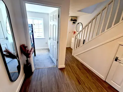 a hallway with stairs and a mirror in a house at Great location very spacious. Sea and castle view in Marazion