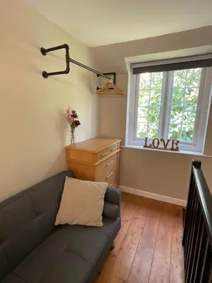 a living room with a couch and a window at The Little Chapel Annexe in Helston