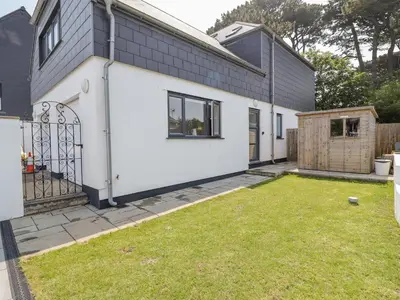 a white house with a yard in front of it at Sea Holly in St Ives