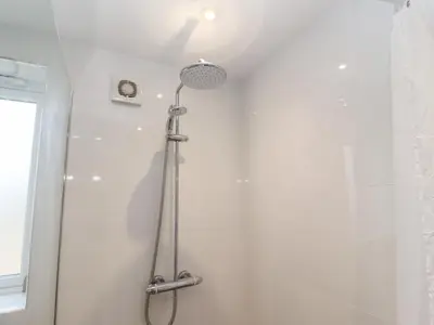 a shower with a shower head in a bathroom at Sea Holly in St Ives