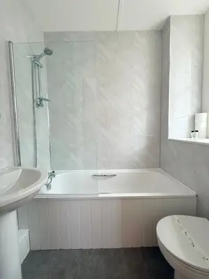 a bathroom with a tub and a toilet and a sink at The Western in St Ives