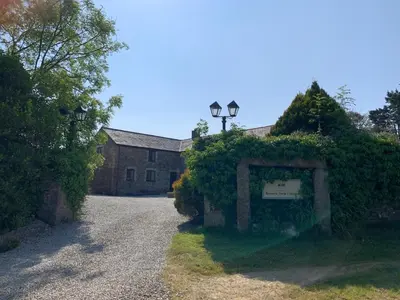 a house with a sign in front of a driveway at Rescorla Retreats- Poldark in Mevagissey
