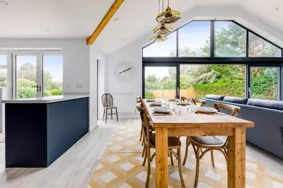 a dining room and kitchen with a table and chairs at The Garden House in Wadebridge