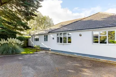 a white house with a driveway at The Garden House in Wadebridge